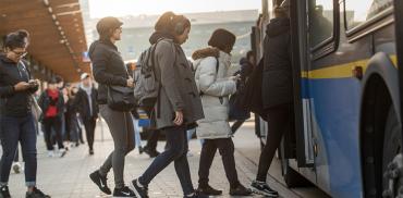Students enter a bus at the UBC Bus Exchange