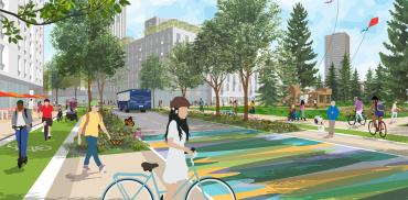 A person with a bike waiting at a decorated crosswalk.